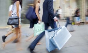 Shoppers walking by with shopping bags