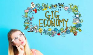a woman thinking about the words "gig economy"