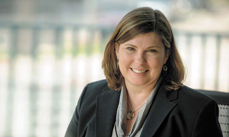Laura-Huckabee-Jennings Laura Huckabee-Jennings smiling at the camera. She is seated, wearing a black blazer.