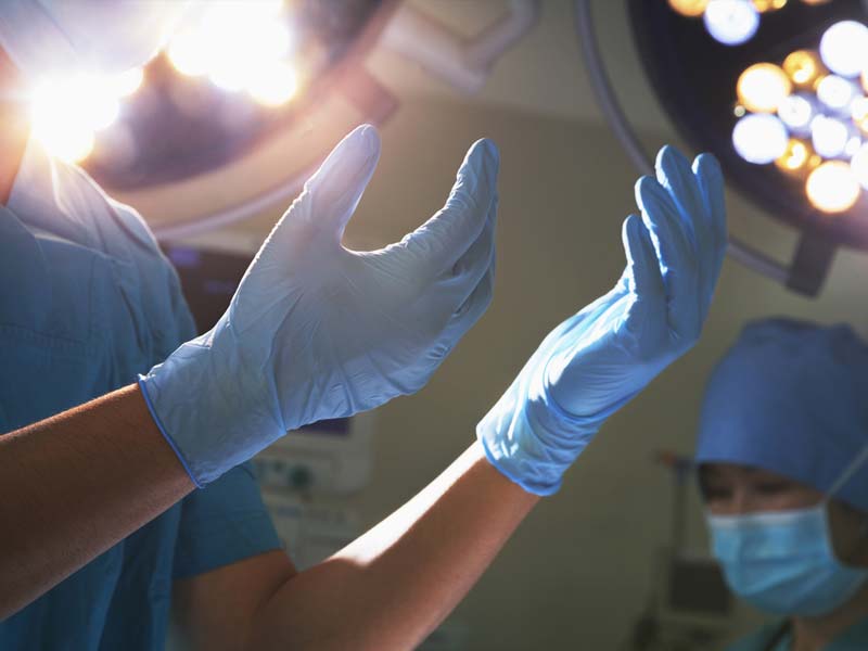 Doctors getting ready for surgery wearing latex gloves