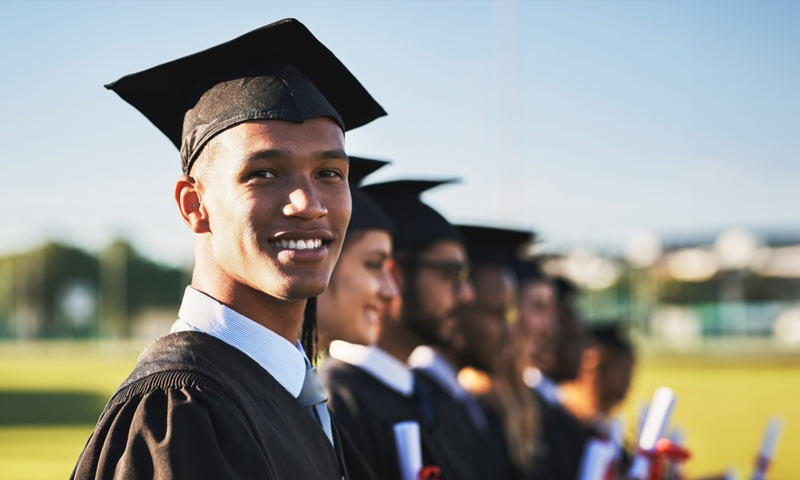 A group of young people a wearing gowns at a graduation ceremony