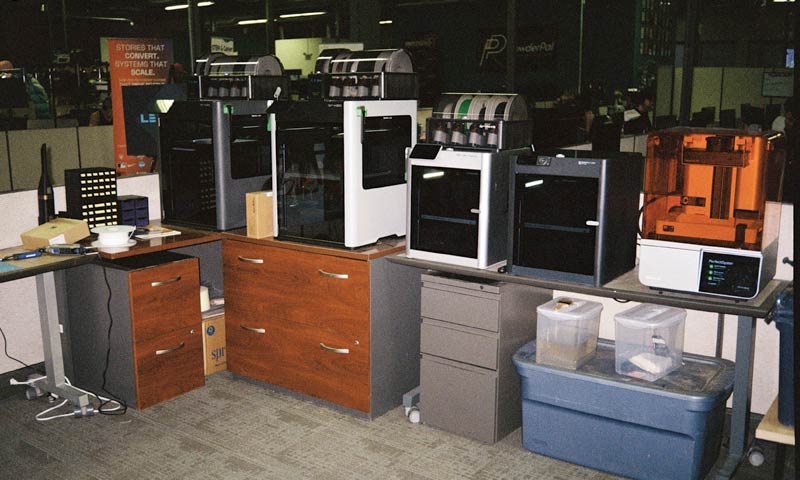 3D printing equipment in a cluttered room