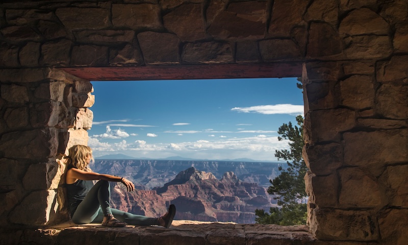 A woman is entranced by the immense beauty of the Grand Canyon at The North Rim, Arizona